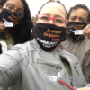 Latino voters take a selfie in masks with "I Voted" stickers