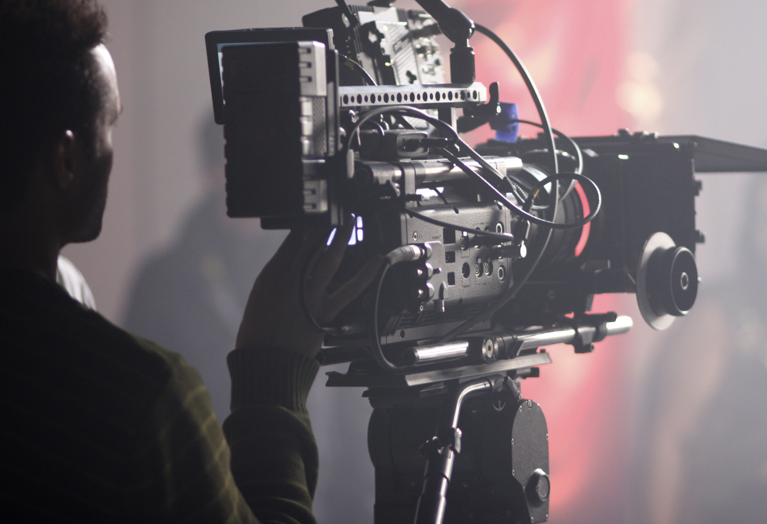 Digital cinema camera on a foggy/smoky movie set movie director behind camera