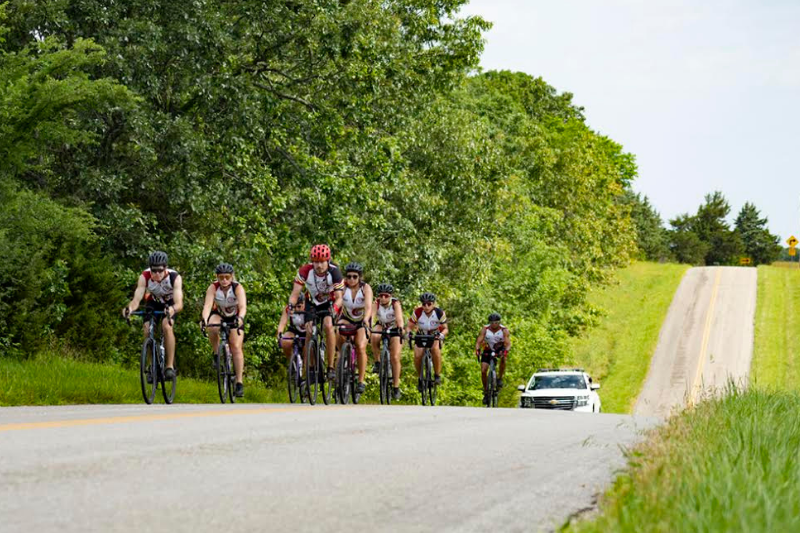 A group of cyclists riding on the road