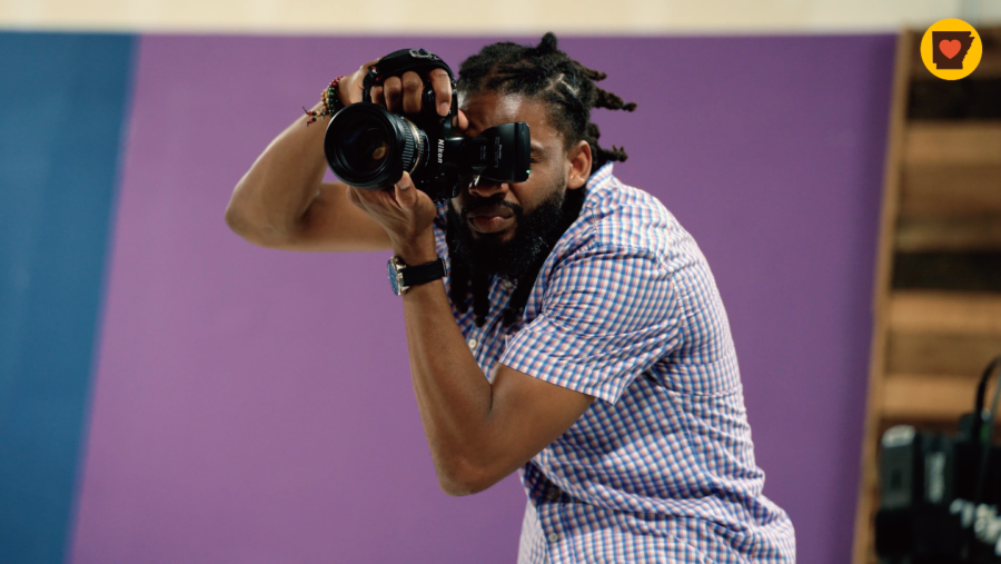Black man taking a picture with a camera