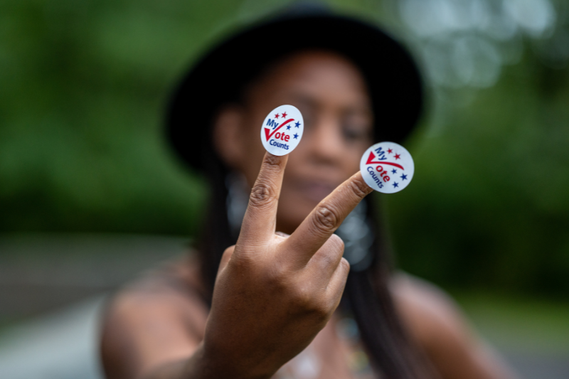 Black woman with "My Vote Counts" stickers on her fingers