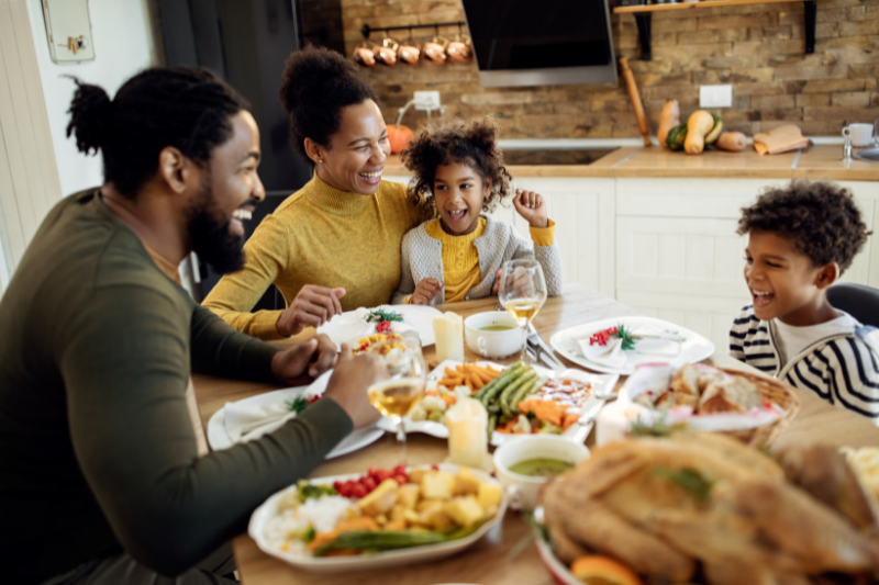 Black family enjoying Thanksgiving dinner