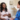 Pregnant Black woman meeting with Asian female nurse in clinic