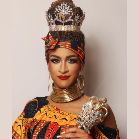 Miss Gay Arkansas America Athena Sinclair in a red, black and yellow outfit wearing her crown and holding her scepter