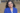 Diana Gonazles Worthen wears a royal blue blazer while smiling on a deck